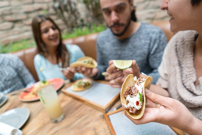 personas comiendo tacos